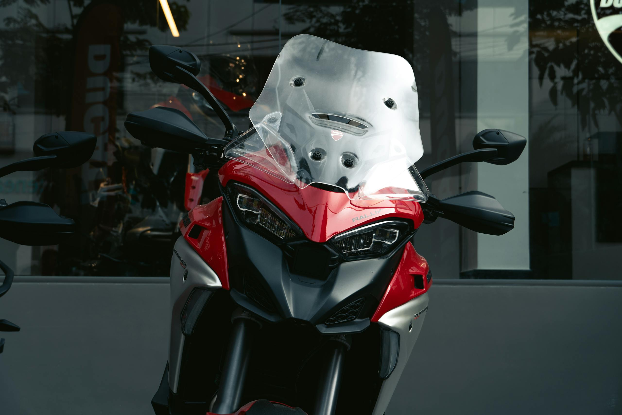 Front view of Ducati motorbike displayed in a modern showroom.